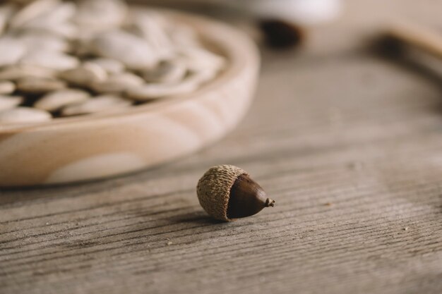 Hazelnut next to wooden plate