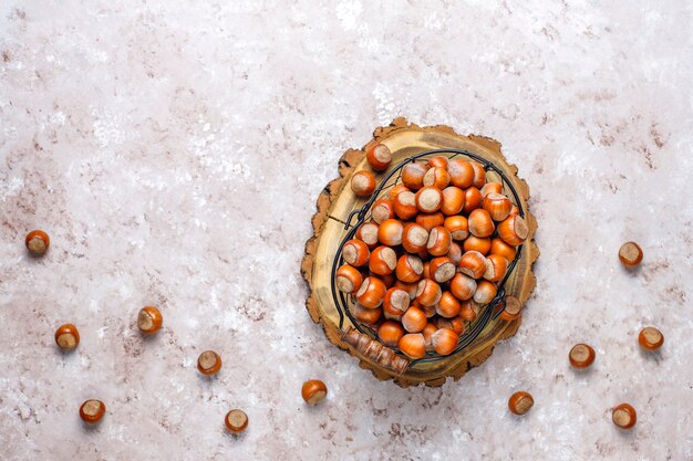 Hazelnuts on concrete background, top view