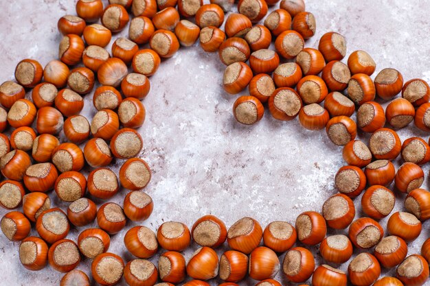 Hazelnuts on concrete background, top view