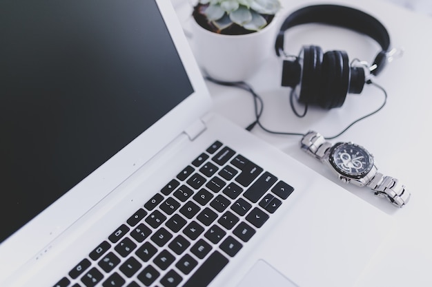 Headphones, clock and laptop