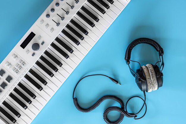 Headphones and keys on a blue background top view