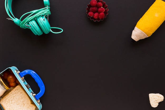 Headphones and pencil case near lunchbox