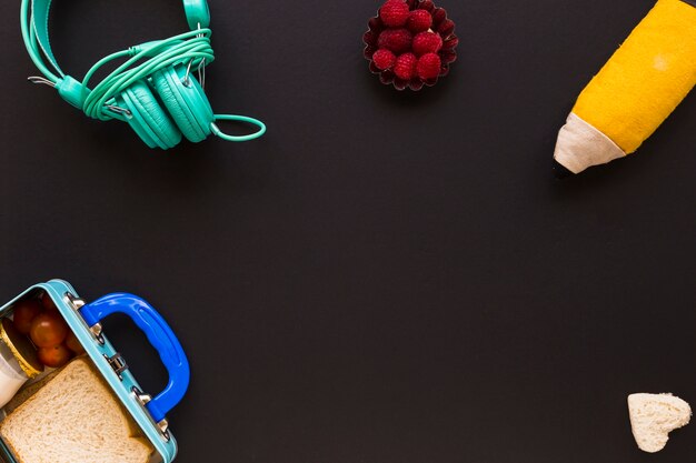 Headphones and pencil case near lunchbox