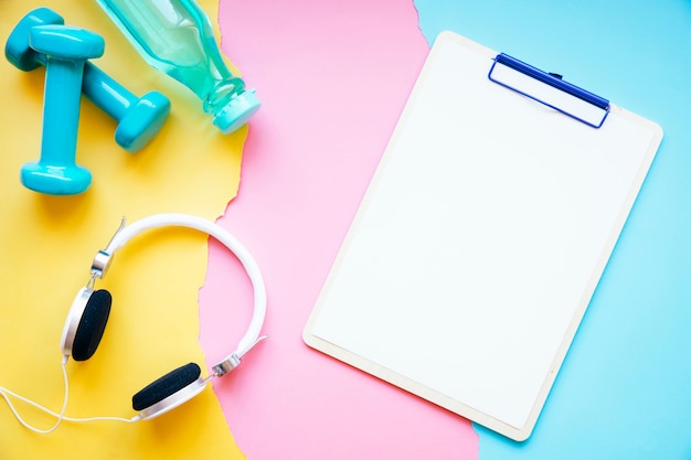 Headphones and sports equipment near clipboard