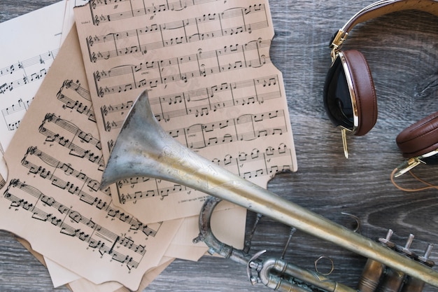 Headphones and trumpet near sheet music