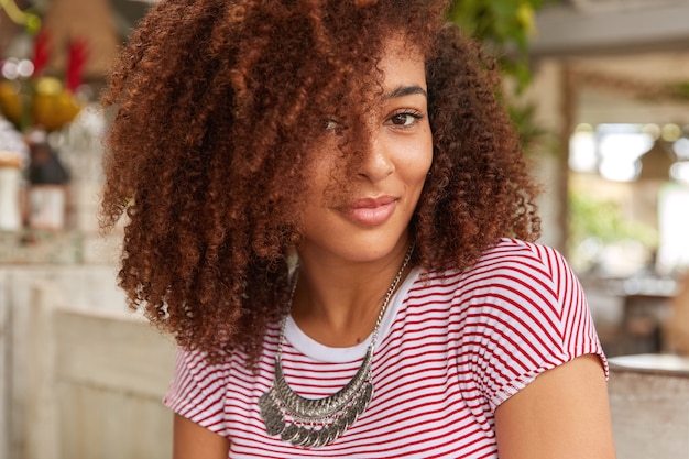 Headshot of attractive woman with curly hair