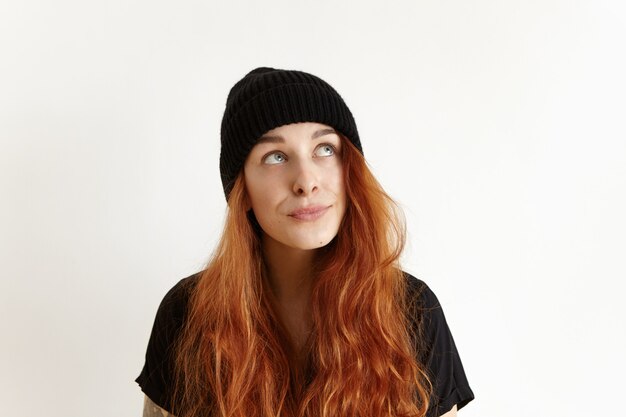 Headshot of beautiful doubtful and indecisive Caucasian teenage girl with messy hairstyle