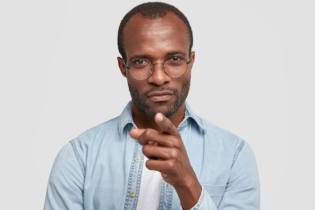 Headshot of dark skinned male with serious expression