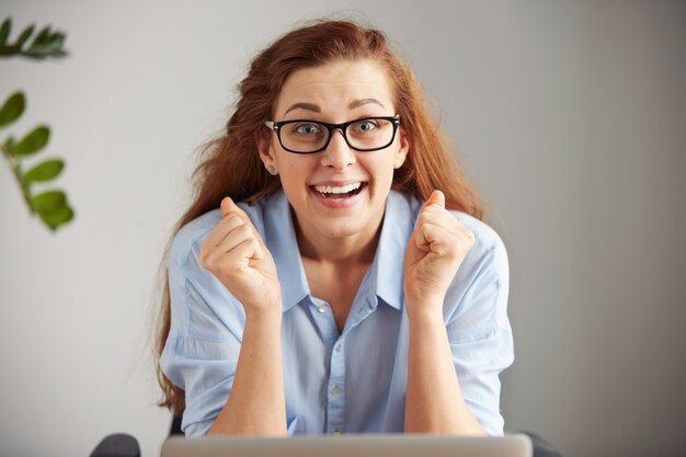 Headshot of euphoric successful businesswoman