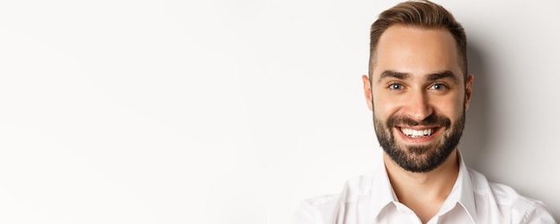 Free photo headshot of handsome bearded man smiling standing against white background