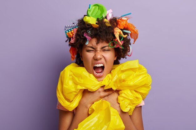 Headshot of irritated bothered woman posing with garbage in her hair