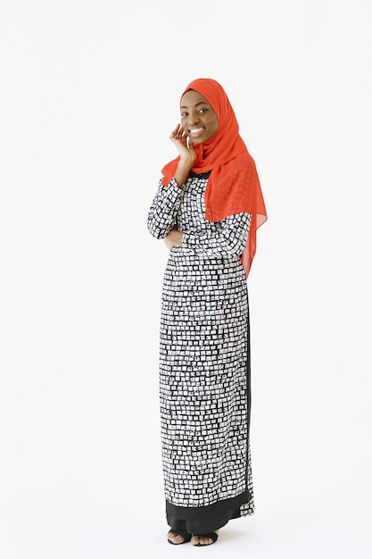Free photo headshot of lovely satisfied religious muslim woman with gentle smile, dark healthy skin, wears scarf on head. isolated over white background.