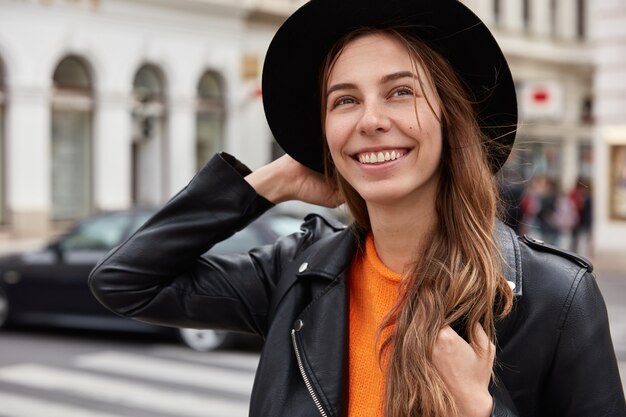 Headshot of optimistic European woman feels free and delighted