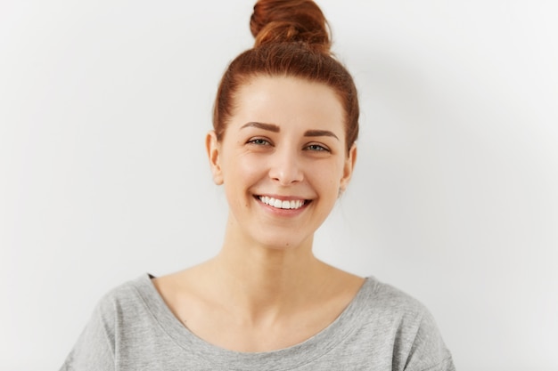 Free photo headshot of relaxed young ginger female hipster with perfect beautiful smile looking with happy expression