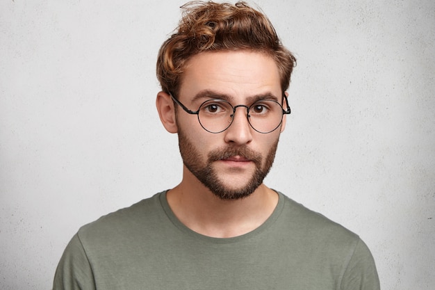 Free photo headshot of serious clever man professor going to conduct lecture, wears spectacles