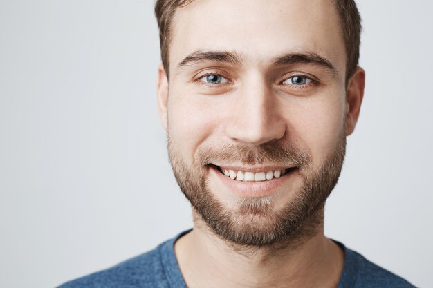 Headshot of smiling happy man with white teeth