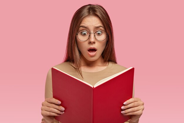 Headshot of surprised woman with terrified expression