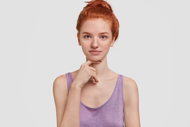 Headshot of tender ginger female with freckled skin