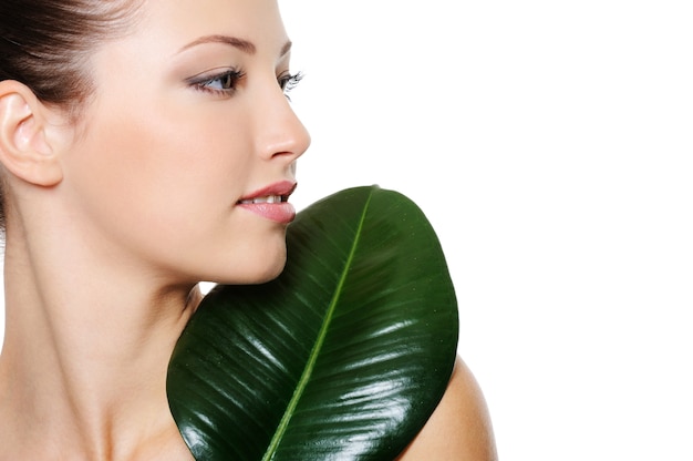 Health profile portrait of beautiful nice young woman with green leaf