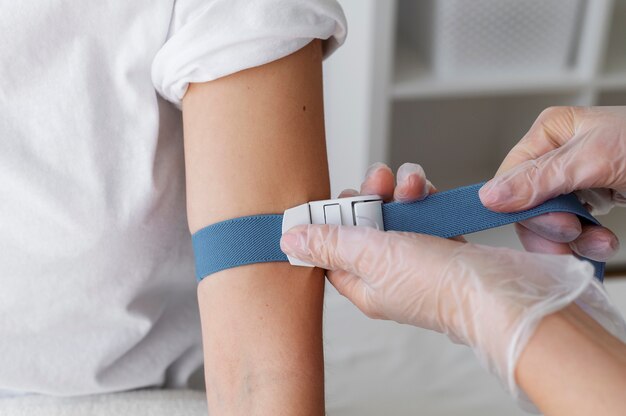 Healthcare professional preparing arm for blood draw