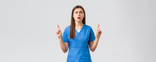 Healthcare workers prevent virus insurance and medicine concept disappointed and angry female nurse