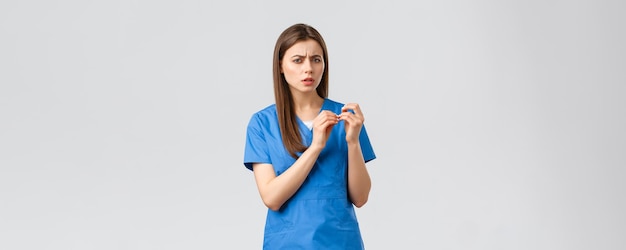 Healthcare workers prevent virus insurance and medicine concept skeptical or confused female doctor
