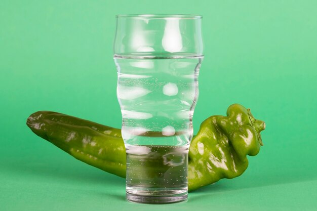 Healthy arrangement with water and green pepper