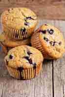 Free photo healthy blueberry banana muffins on a wooden table