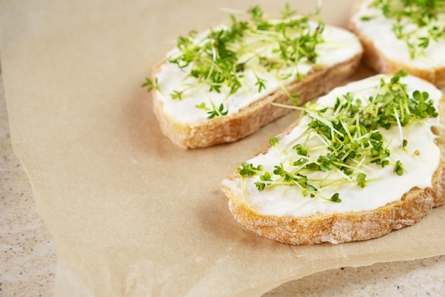 Healthy breakfast. Sandwich with cream cheese and microgreens.