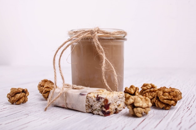 Free photo healthy brown smoothie with walnuts lie on the table