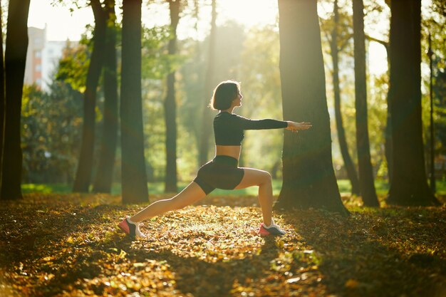 Healthy brunette stretching body before fitness exercises