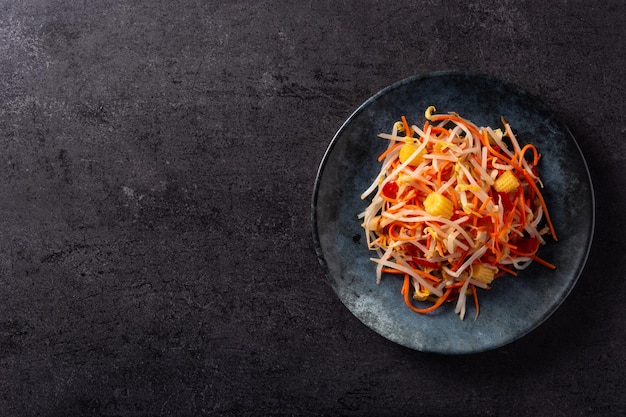 Healthy Chinese cabbage salad on black slate background