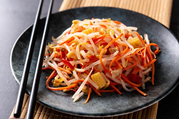 Healthy Chinese cabbage salad in plate on black background