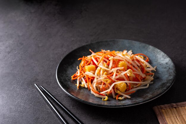 Healthy Chinese cabbage salad in plate on black stone background