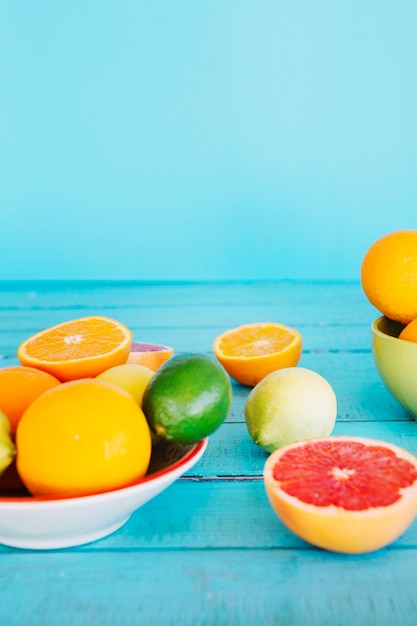 Healthy citrus fruits on blue wooden table top