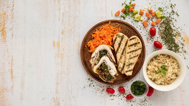 Healthy dish with chicken and vegetables on grunge wooden desk