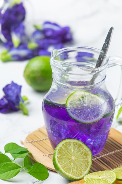 Healthy drink, organic blue pea flower tea with lemon and lime.