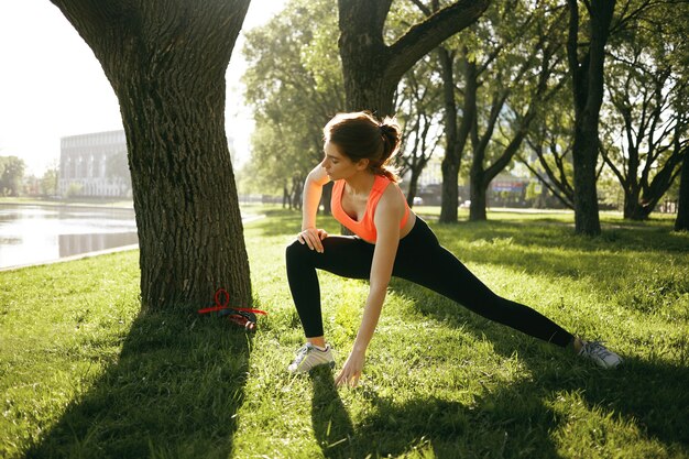 A healthy female is doing exercise outdoor