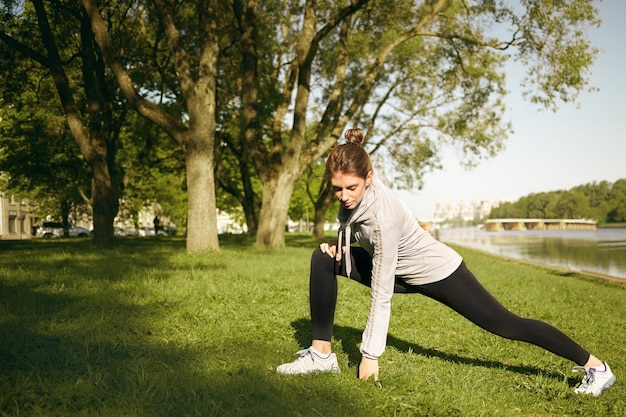 Free photo a healthy female is doing exercise outdoor