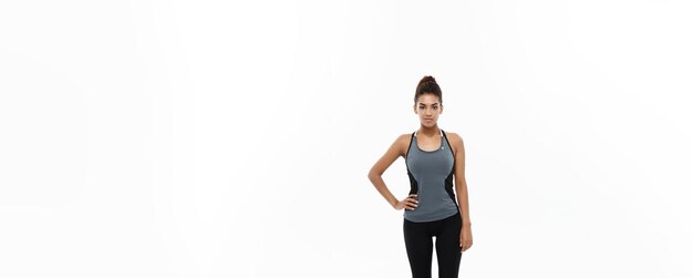 Healthy and fitness concept portrait of african american girl posing with fitness clothes over whit