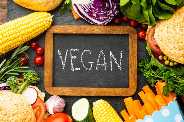 Healthy food arrangement with vegan lettering on chalkboard