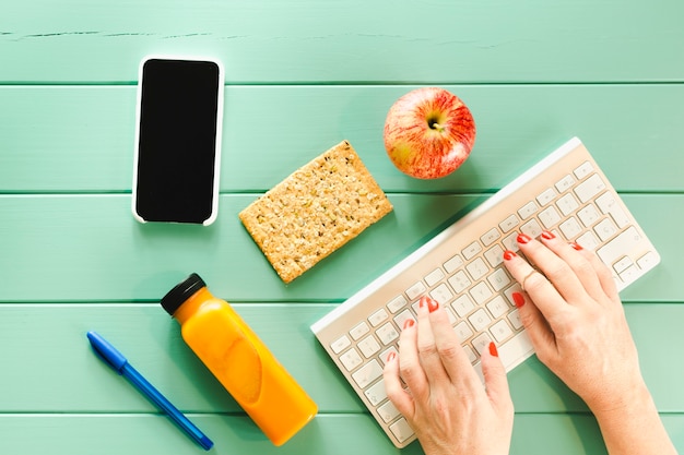 Free photo healthy food concept with hands typing on keyboard