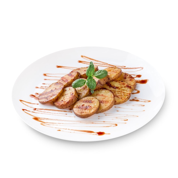 Healthy food: grilled sweet potatoes with basil served with sour tomato sauce close up on a white background. Photo for the menu