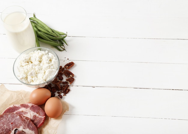 Free photo healthy food ingredients on white wooden table