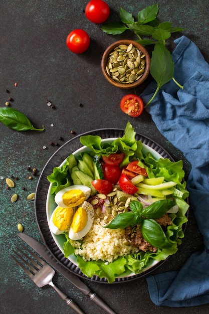 Здоровое питание салат из тунца с яичным салатом, овощами киноа и тыквенными семечками вид сверху Premium Фотографии