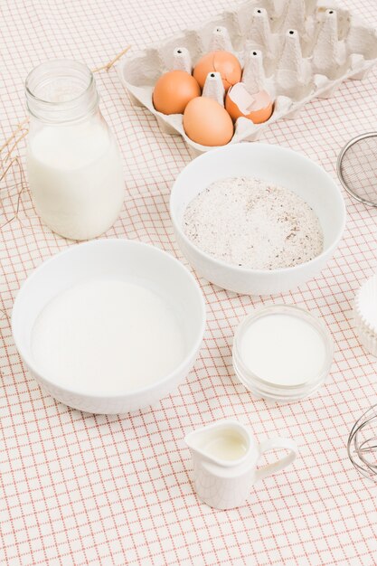 Healthy fresh baking ingredients over textured pattern fabric