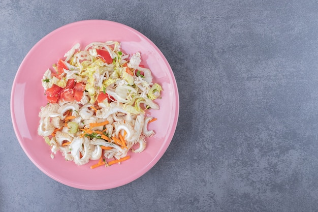 Healthy fresh salad on pink salad.