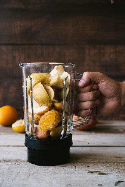 Healthy fruit in mixer front view