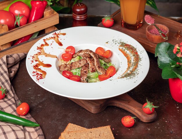 Healthy Grilled Beef Caesar Salad with Cheese, Cherry Tomatoes and lettuce 