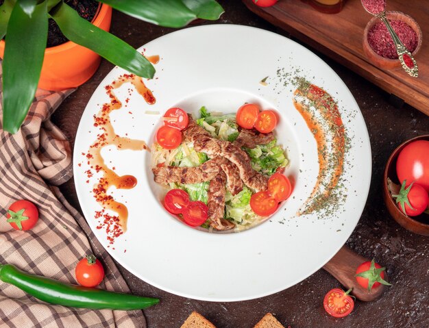 Healthy Grilled Beef Caesar Salad with Cheese, Cherry Tomatoes and lettuce 